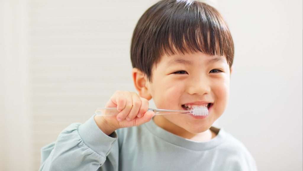 Boy brushing teeth | before school care